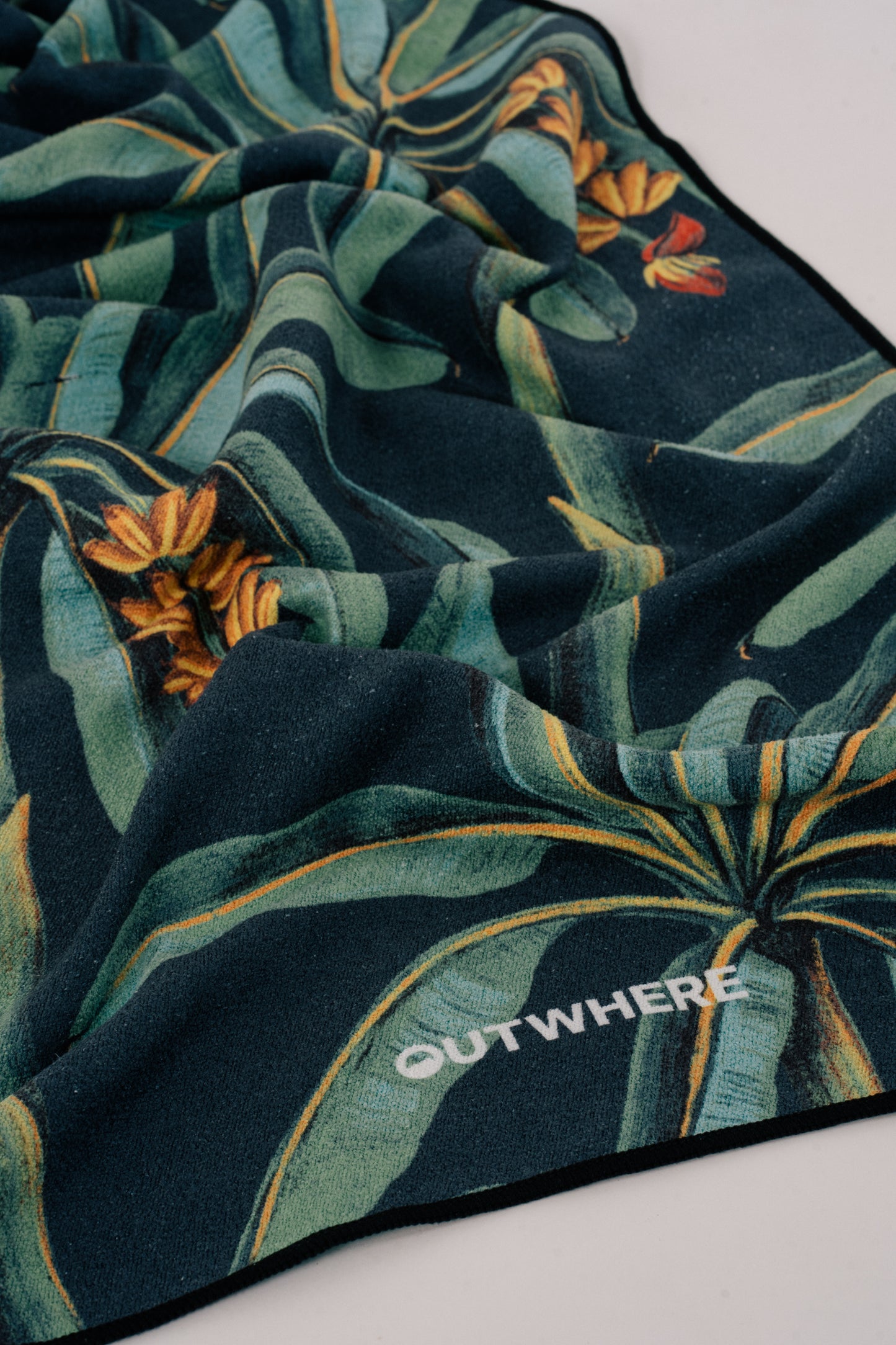 Close up shot of the Outwhere PH Everywhere towel in Saging (Banana) Green showing the material and design details and logo