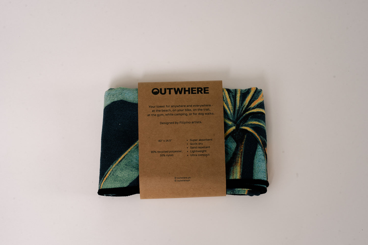 Folded Outwhere PH Everywhere Towel in Saging (banana) Green in Packaging sleeve. Front of packaging sleeve shows product features, dimensions, and social media handles