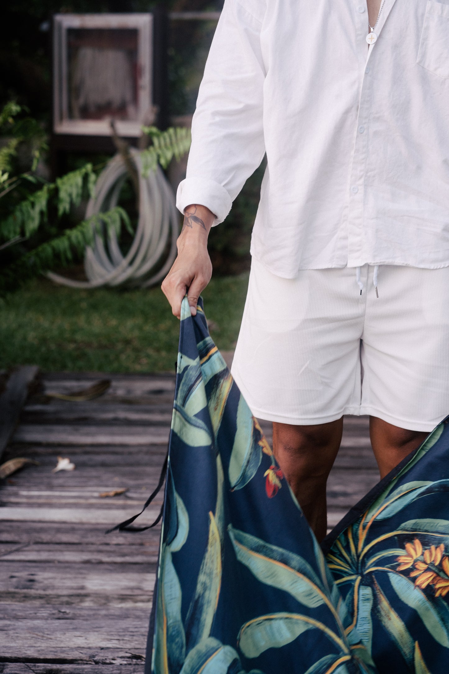 Photo of a man in white clothes holding the ends of the Outwhere PH Latag mat in Saging