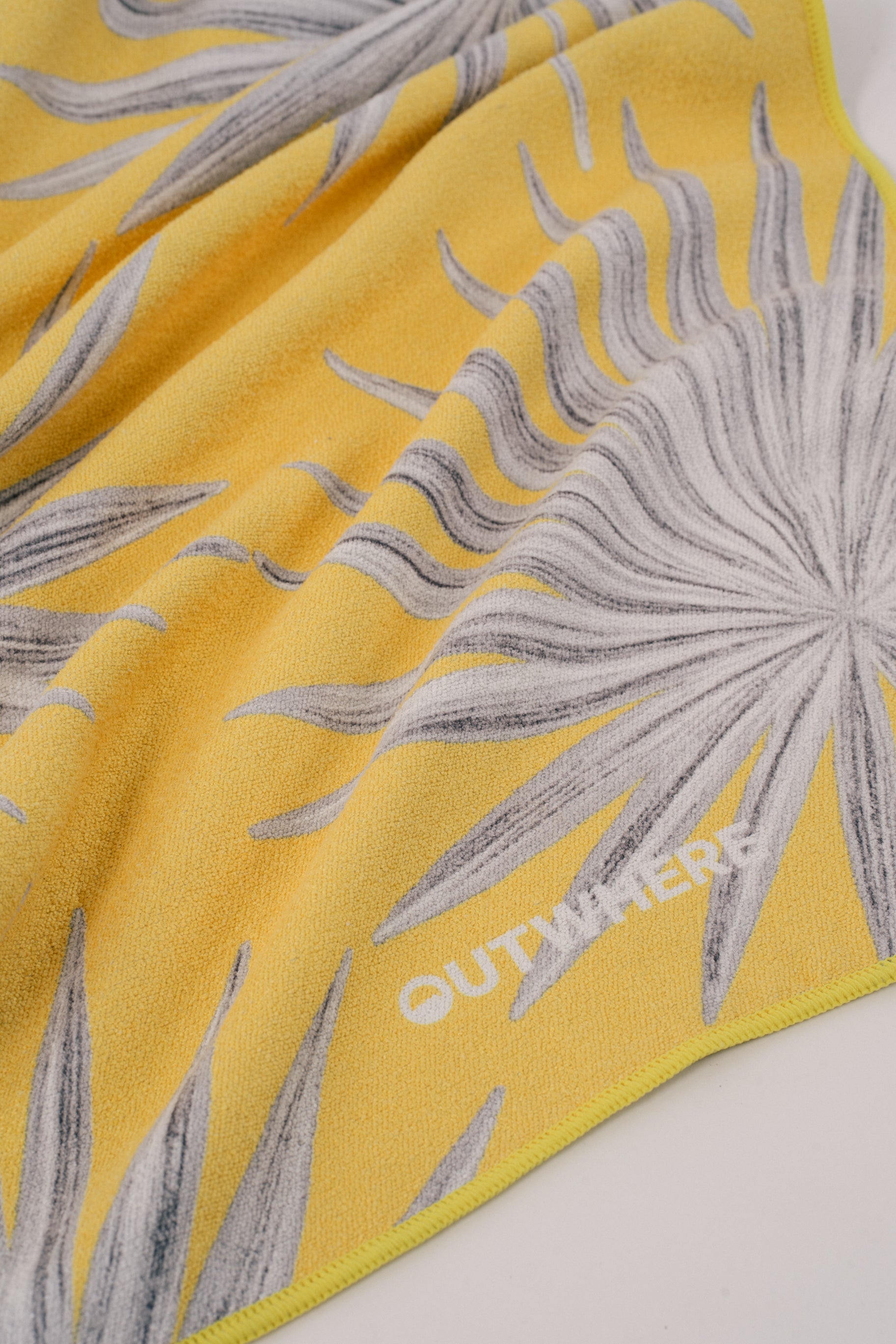 Close up shot of the Outwhere PH Everywhere towel in Anahaw showing the material and design details and logo