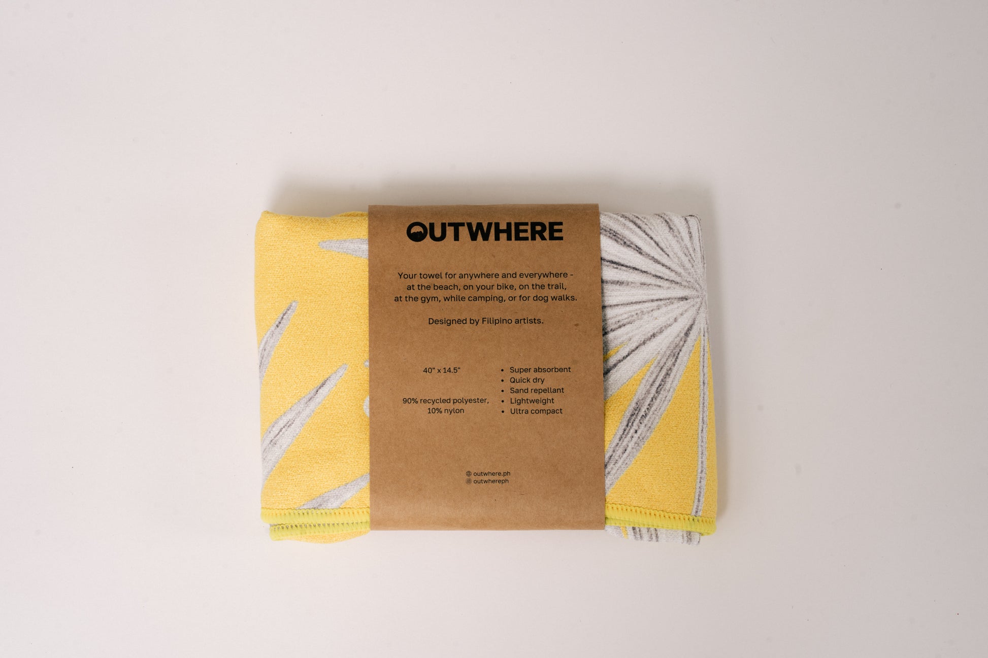 Folded Outwhere PH Everywhere Towel in Anahaw in Packaging sleeve. Front of packaging sleeve shows product features, dimensions, and social media handles