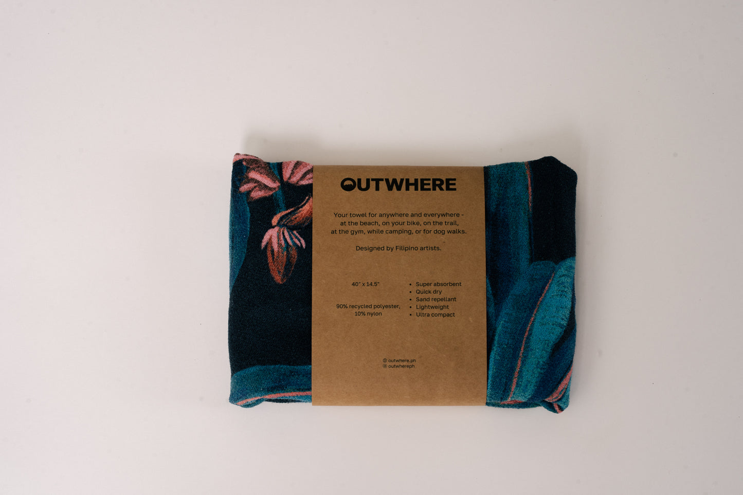 Folded Outwhere PH Everywhere Towel in Saging (banana) Blue in Packaging sleeve. Front of packaging sleeve shows product features, dimensions, and social media handles