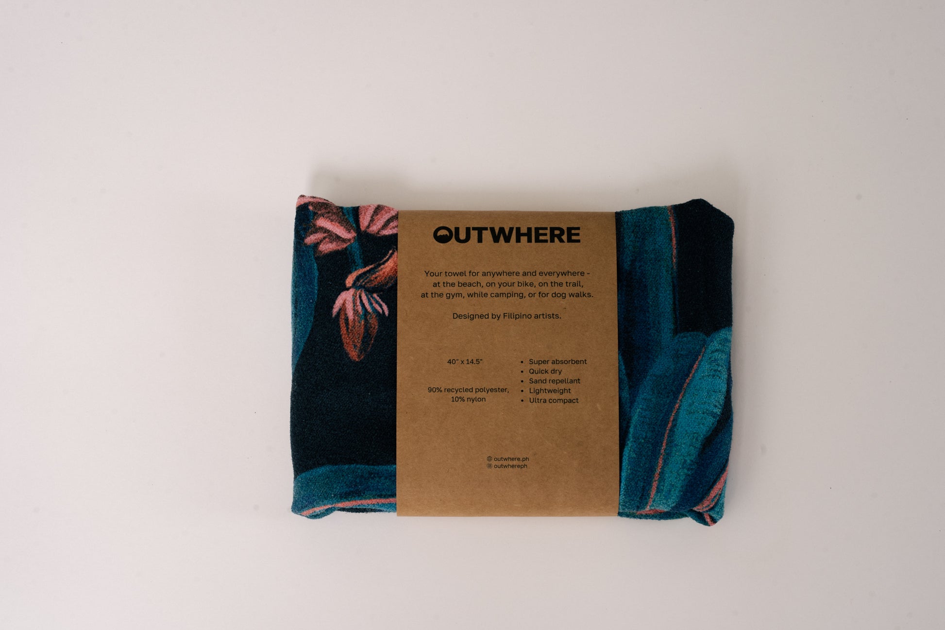 Folded Outwhere PH Everywhere Towel in Saging (banana) Blue in Packaging sleeve. Front of packaging sleeve shows product features, dimensions, and social media handles